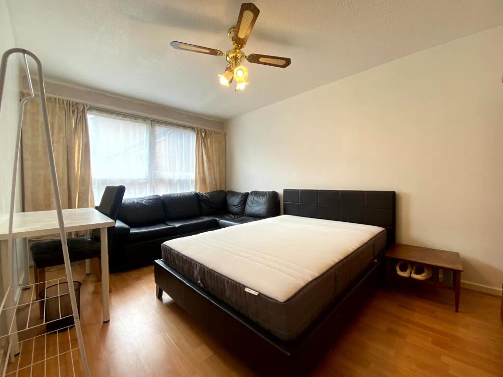 A bright and inviting master bedroom featuring ...