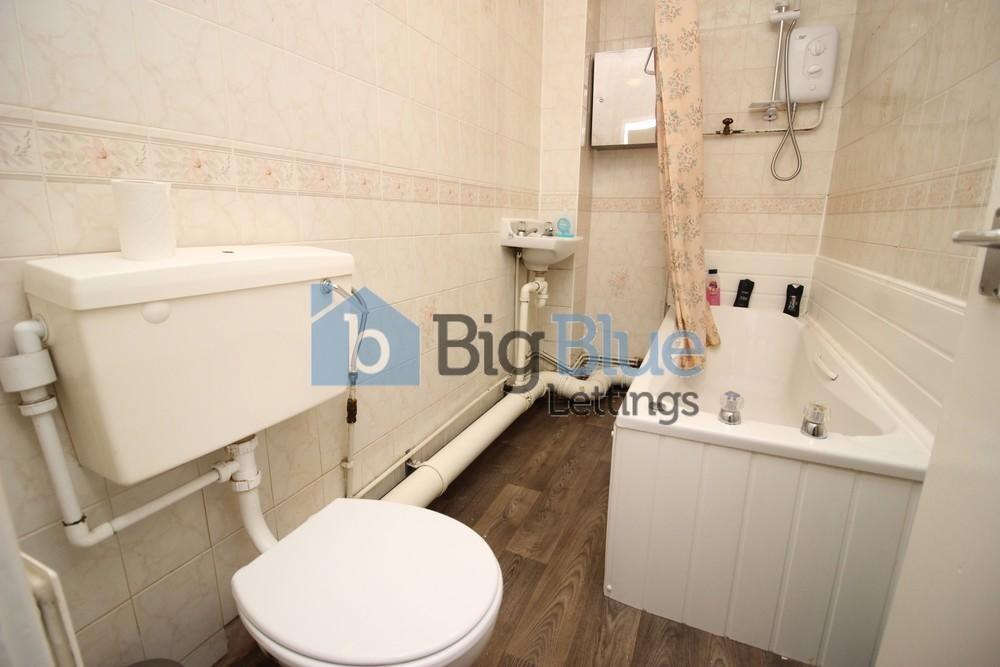 Bright and functional bathroom featuring a bath...