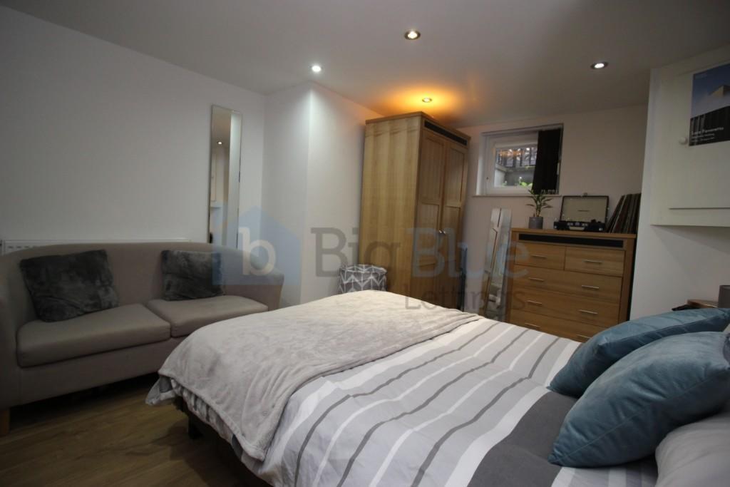 A spacious and inviting master bedroom featurin...