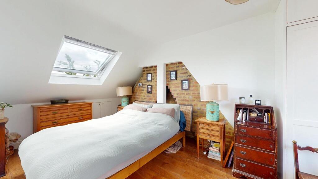 Bright and cozy master bedroom featuring a larg...
