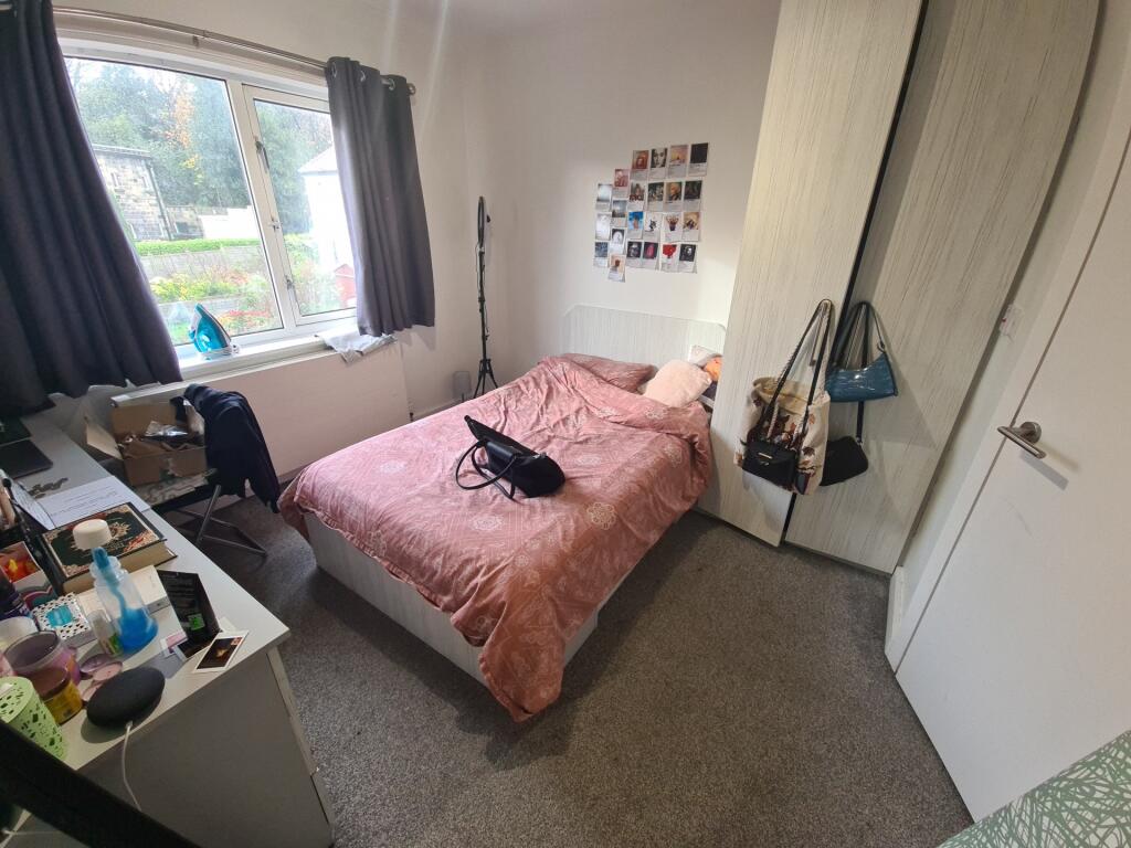 A cozy double bedroom featuring a large window ...