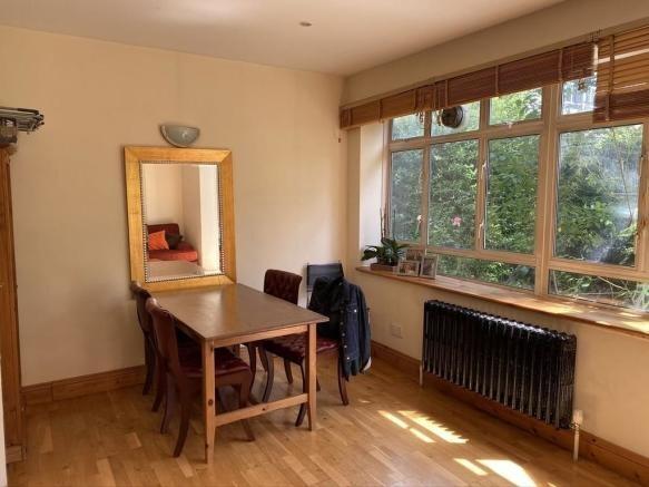 Bright and welcoming living area featuring larg...