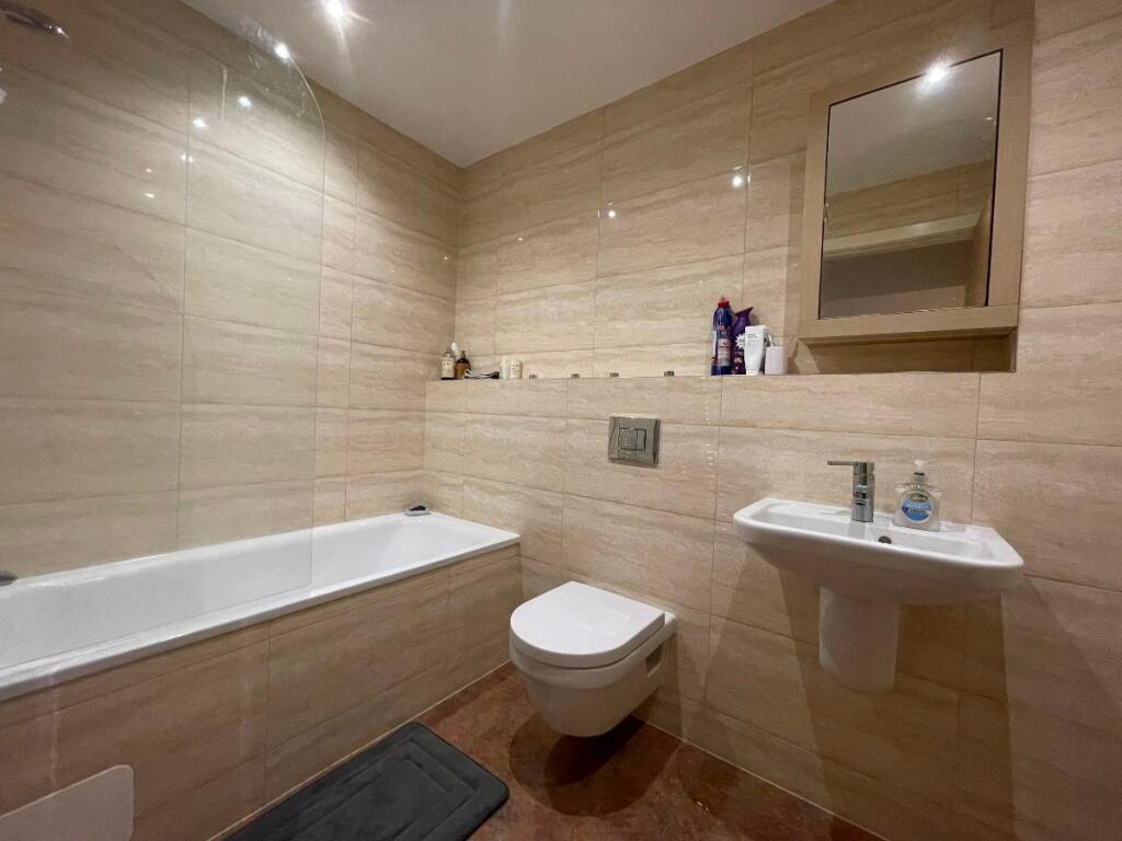A modern and well-maintained bathroom suite fea...