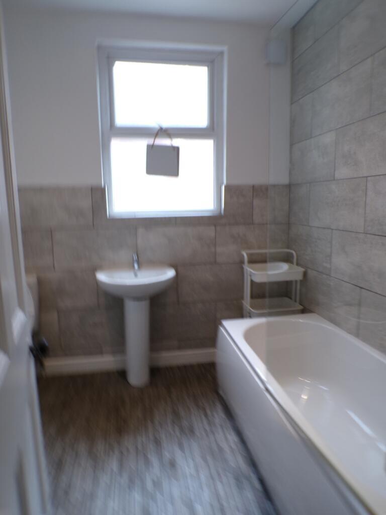 A modern bathroom featuring a sleek bathtub and...