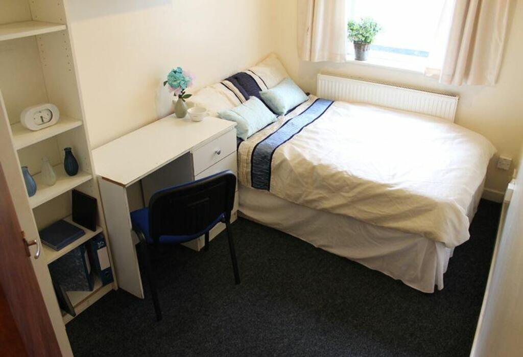 Cozy double bedroom featuring a comfortable bed...
