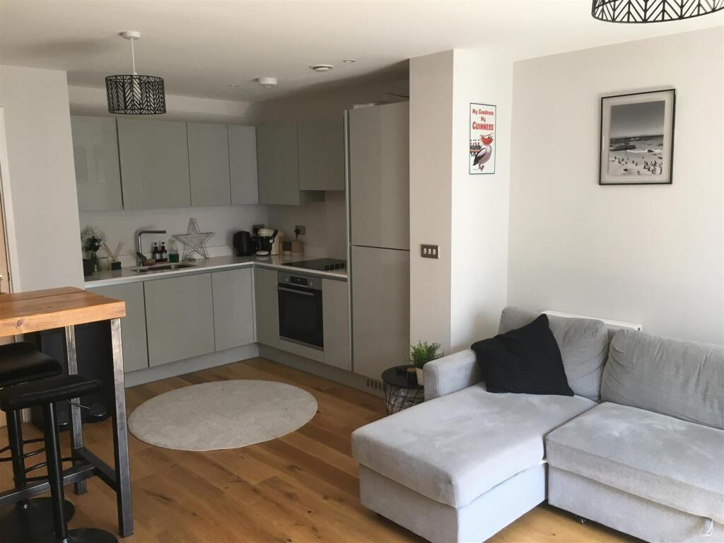 A modern and cozy living room featuring a comfo...