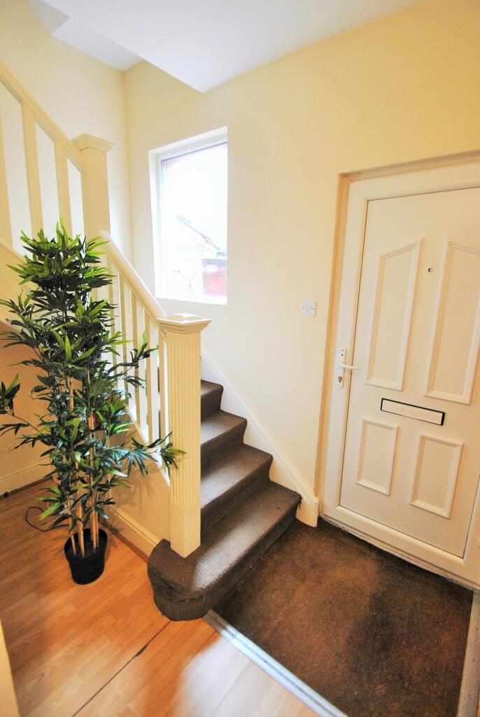 Welcoming hallway featuring natural light and s...