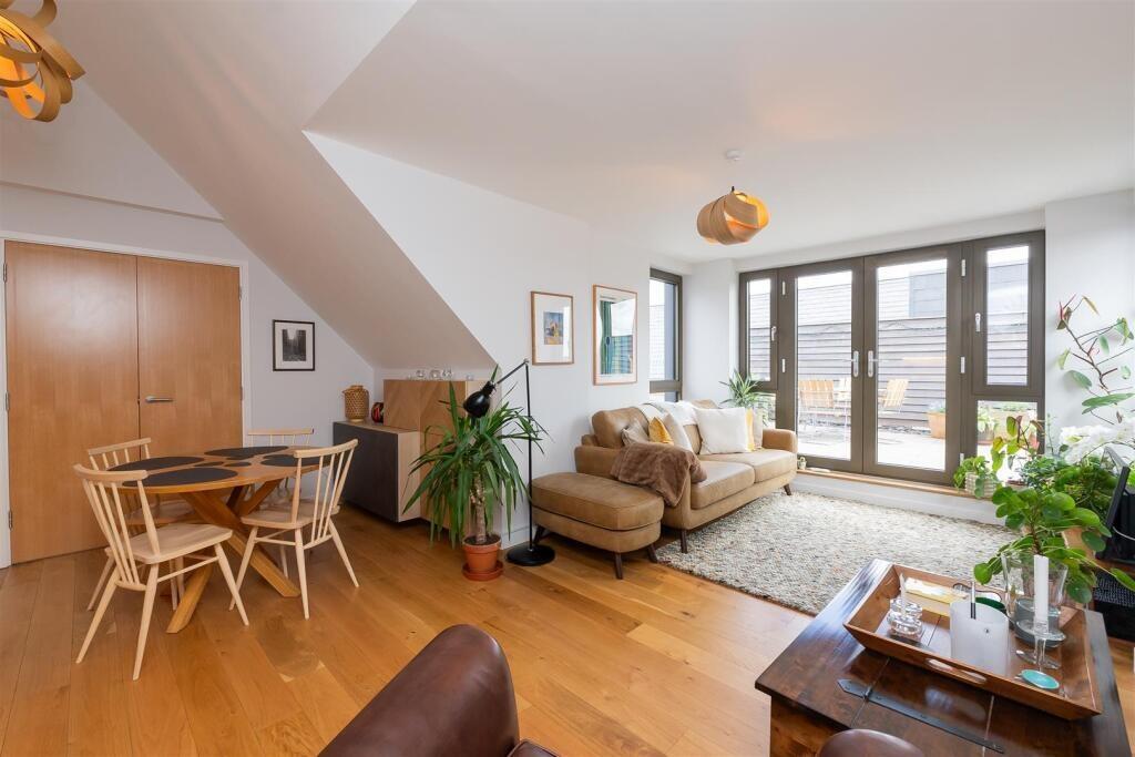 Bright and inviting living room featuring large...