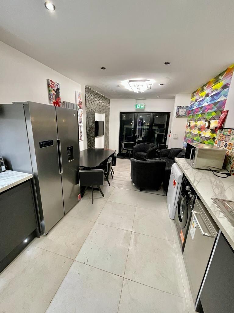 Modern kitchen with sleek appliances and ample ...