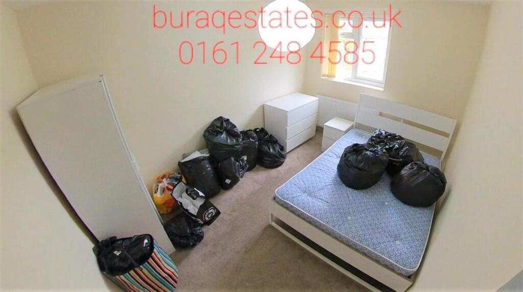 Compact bedroom with a single bed frame and mat...