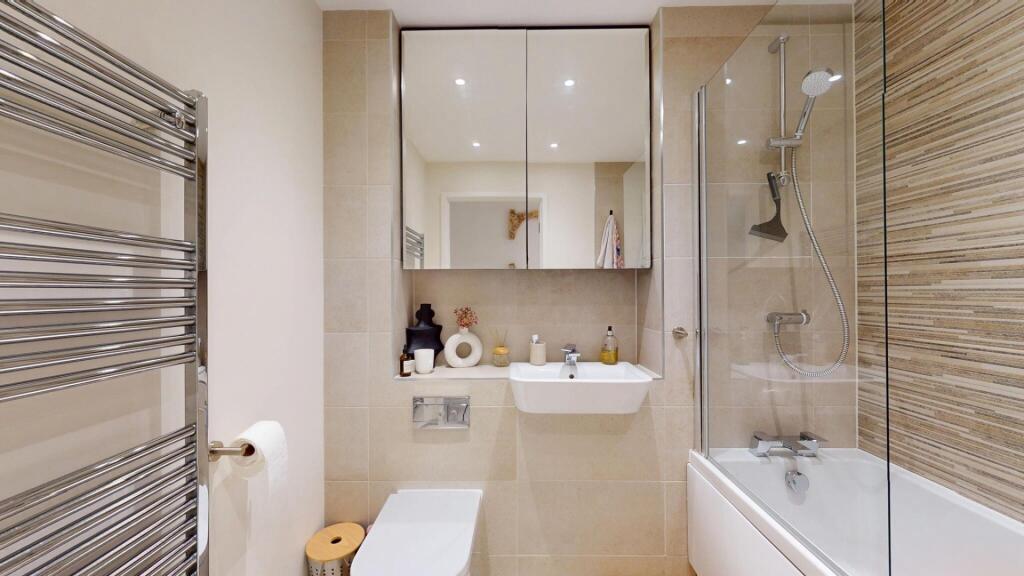 A clean and modern bathroom featuring a spaciou...