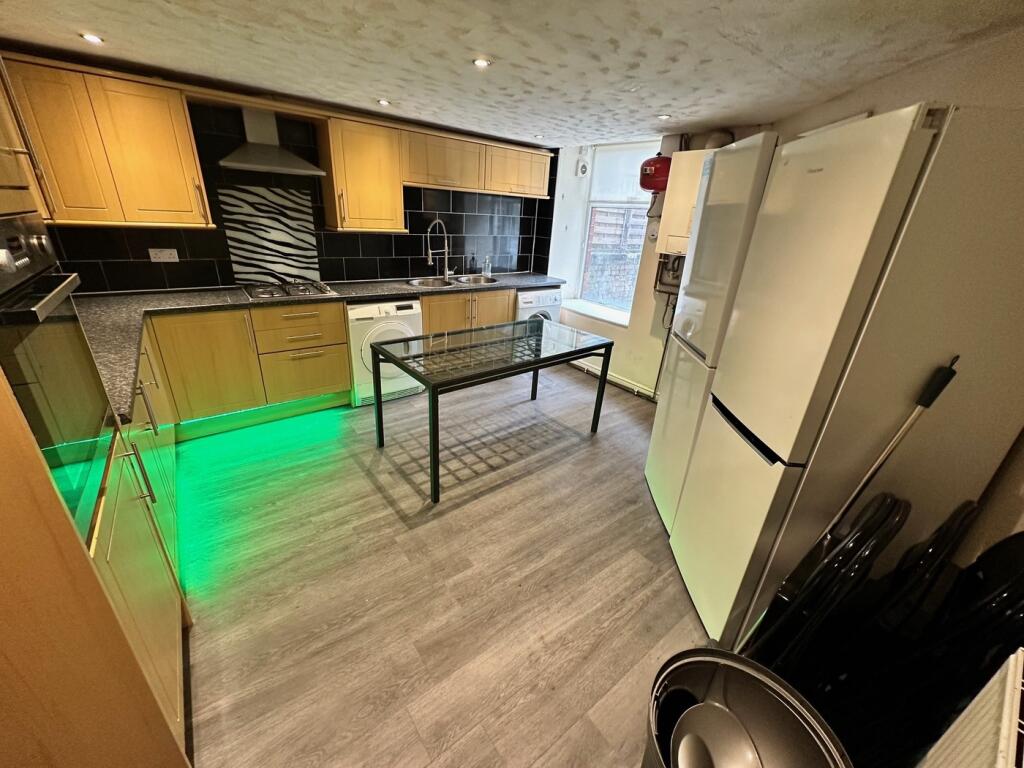 Modern kitchen featuring sleek cabinetry, ample...