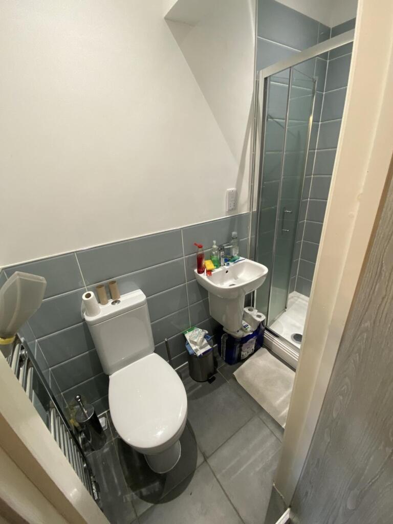 A modern bathroom featuring a sleek shower, con...