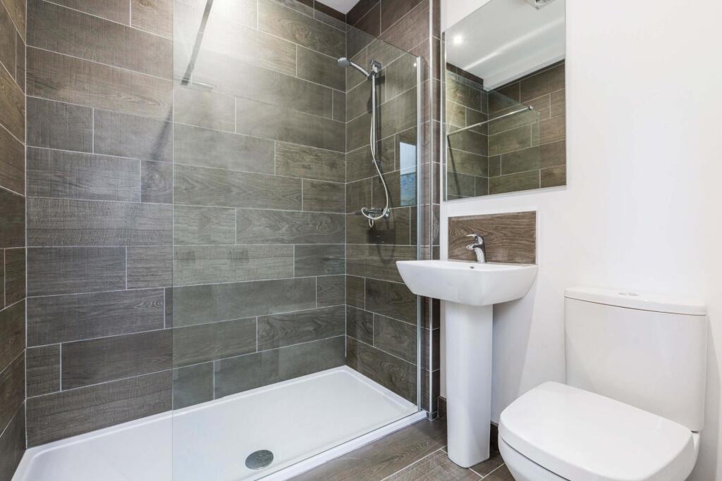 Modern ensuite-style bathroom with a walk-in gl...