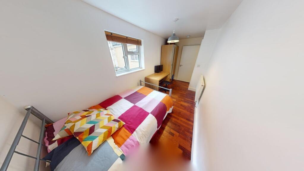 A bright and inviting double bedroom featuring ...