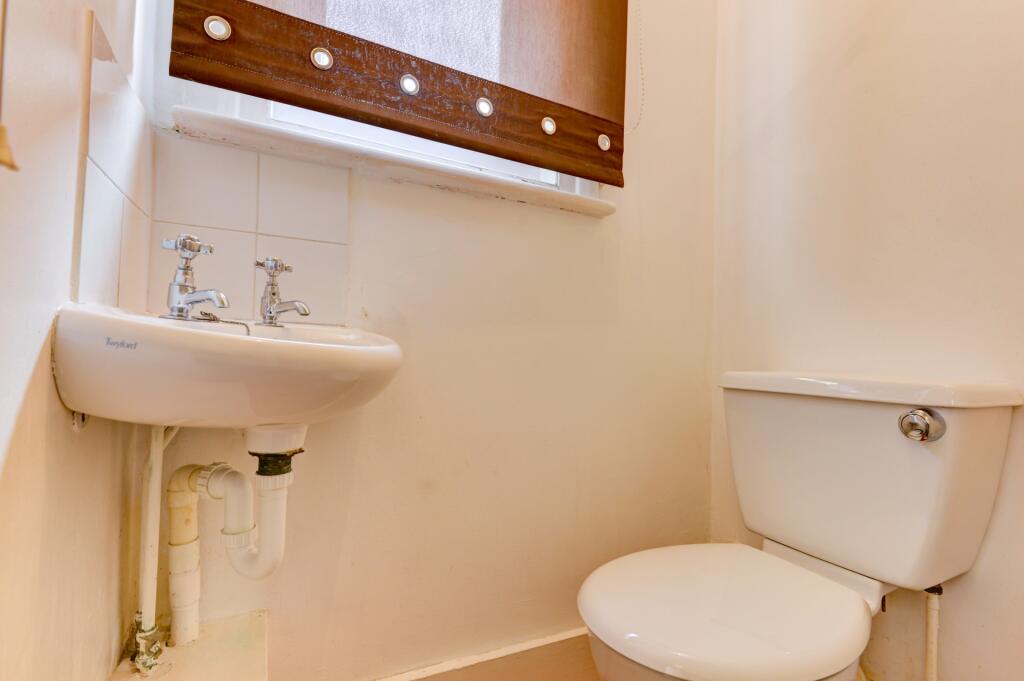 Bright and clean toilet room with a white ceram...