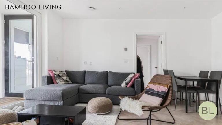 Bright and modern living room featuring a spaci...