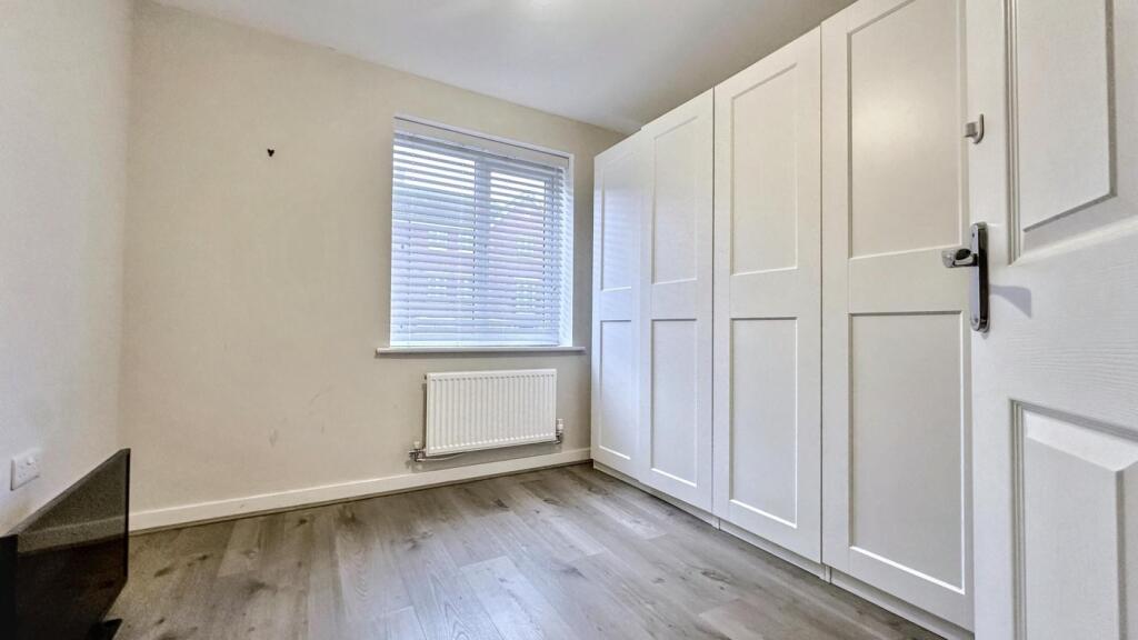 A bright and tidy double bedroom featuring ampl...