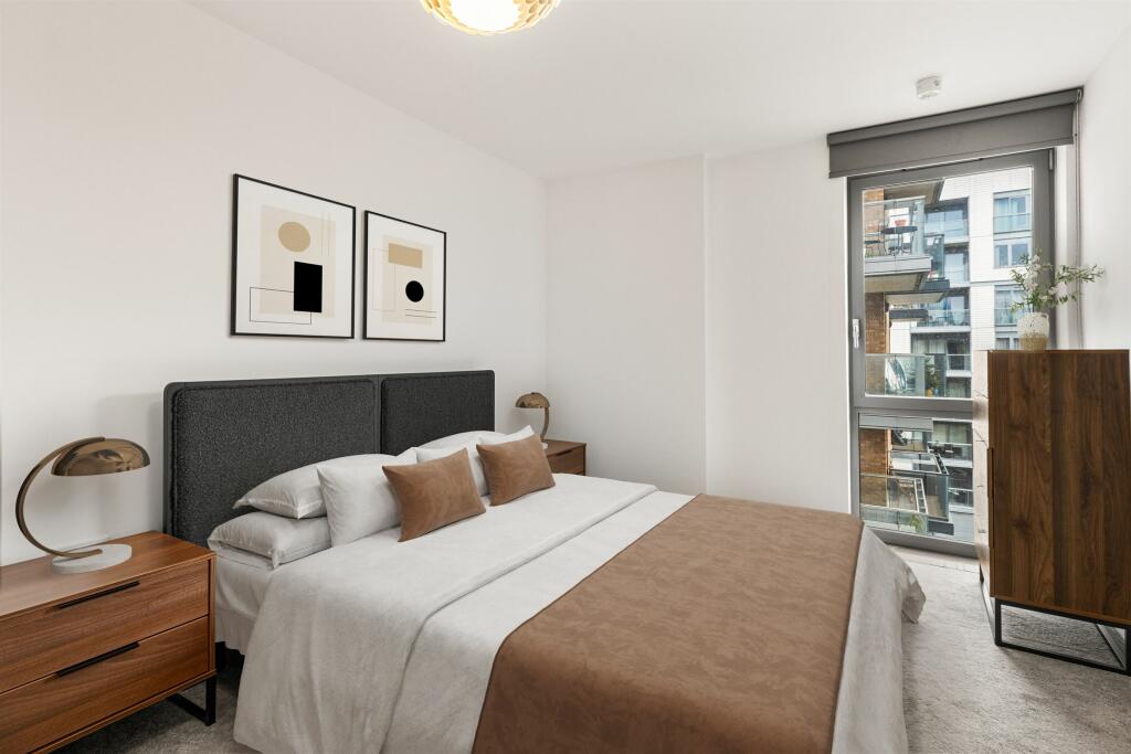 Experience serenity in this elegantly designed bedroom, boasting modern decor and abundant natural light.
