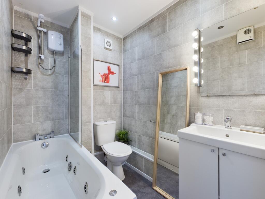 A modern and spacious bathroom featuring a luxu...