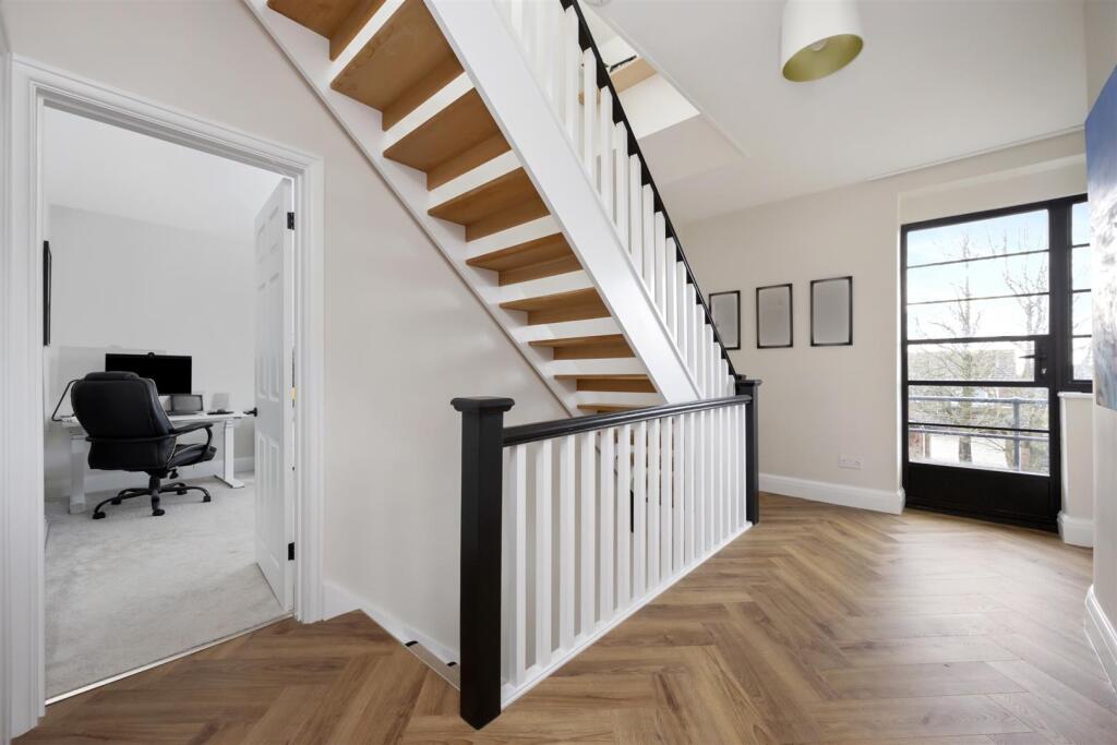 Stairs rising to Second Floor