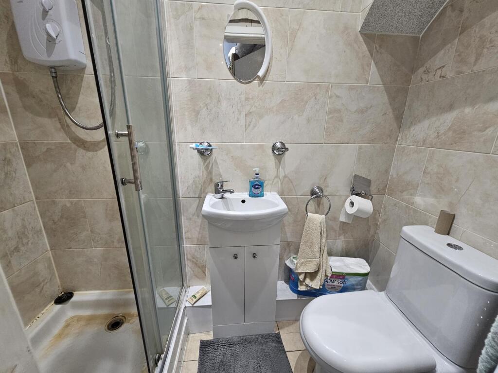 A modern bathroom featuring a clean shower encl...