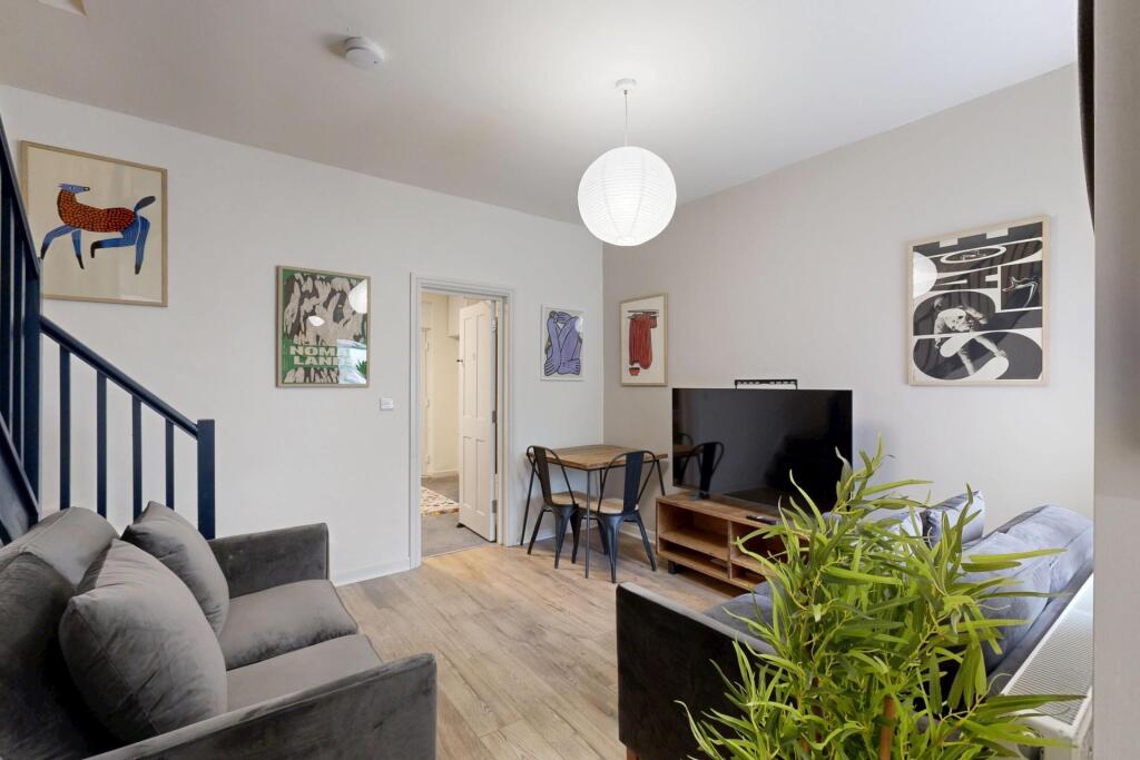 Bright and modern living room featuring a spaci...