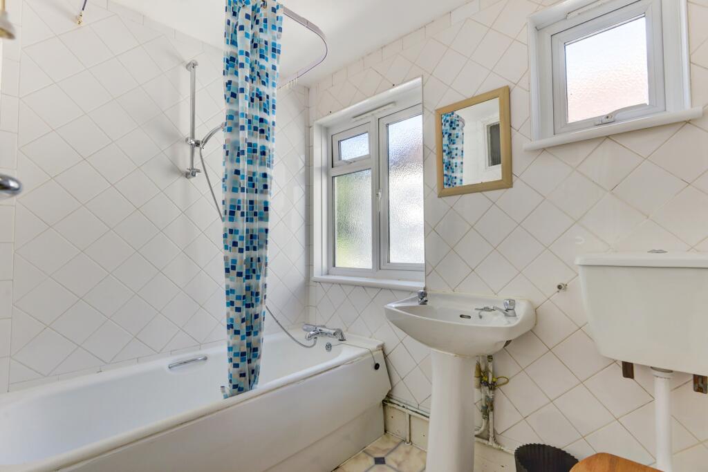 Bright and clean bathroom featuring a full-size...