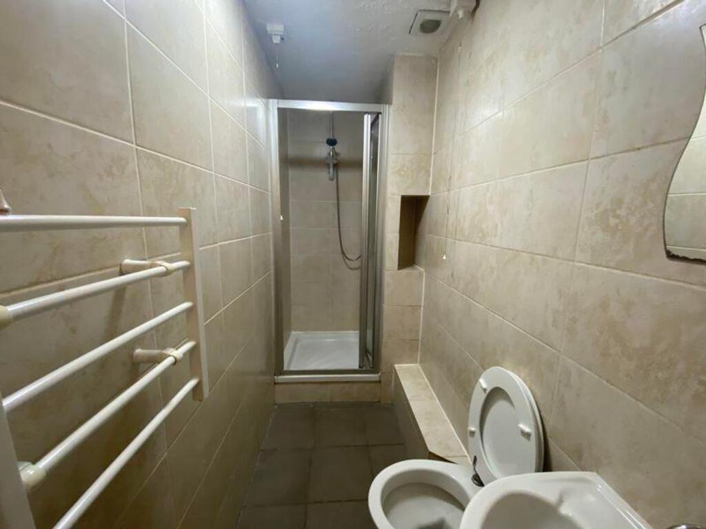 A functional bathroom featuring a shower and mo...