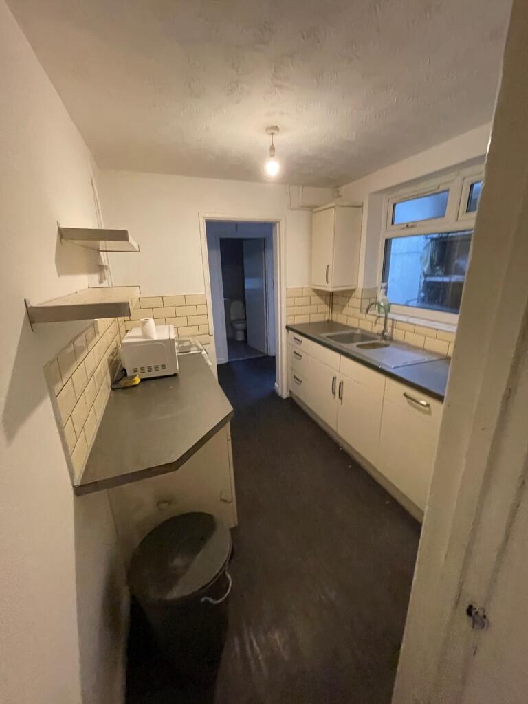 A tidy kitchenette with ample storage and good ...