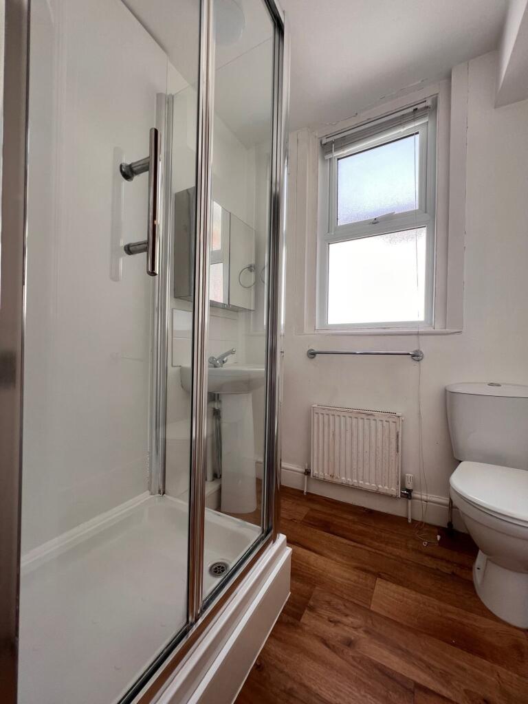 Bright and clean bathroom featuring a modern gl...