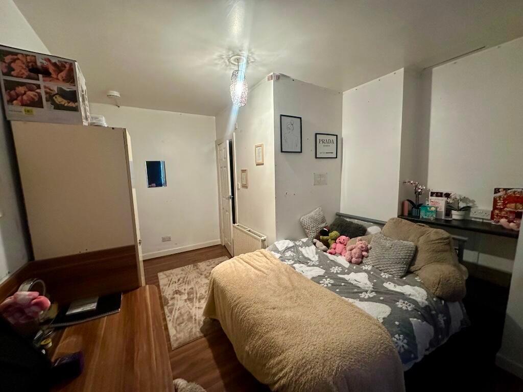 Cozy double bedroom featuring a comfortable bed...
