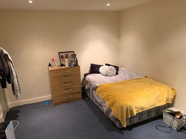 A cozy bedroom featuring a comfortable double b...