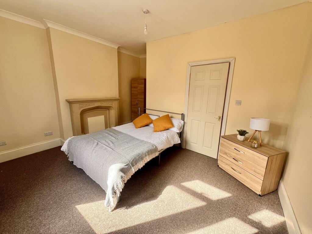 A bright and inviting double bedroom featuring ...
