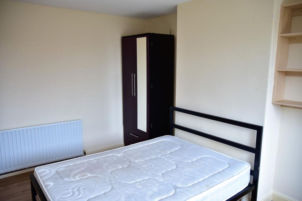 A clean and bright bedroom featuring a simple b...