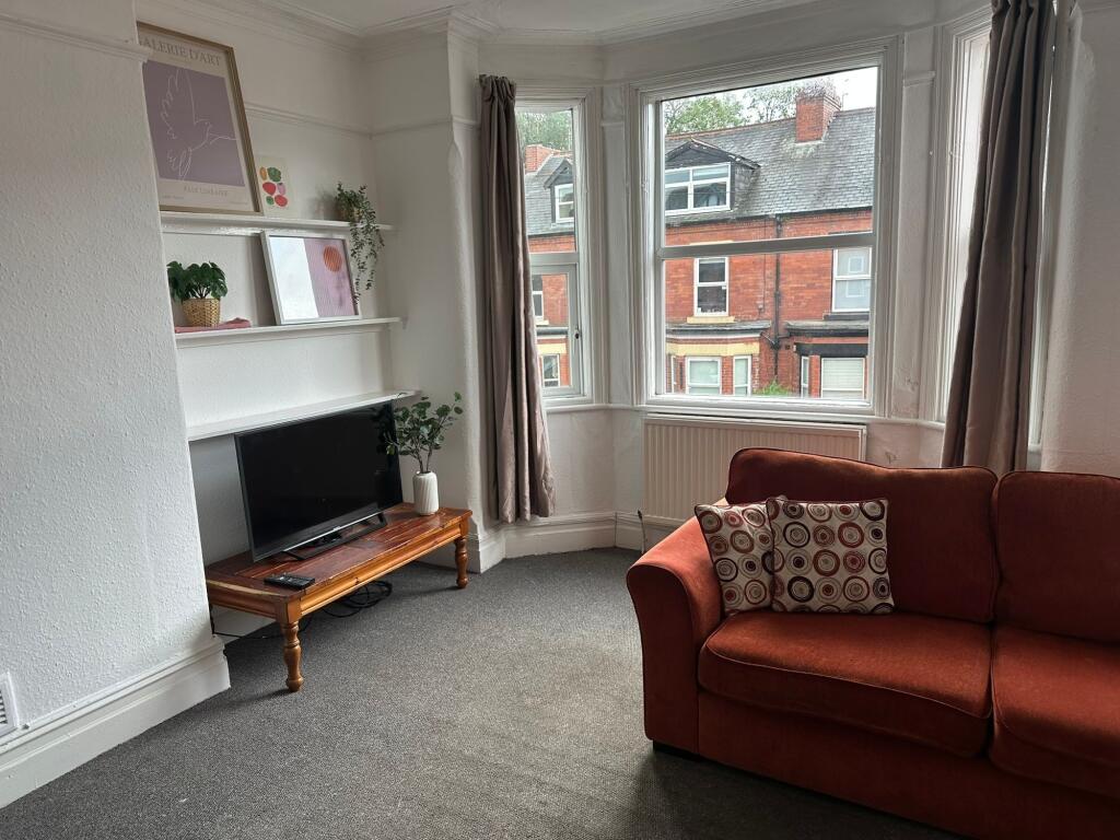 Bright and welcoming living room with large bay...