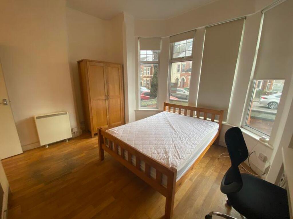A bright and spacious double bedroom featuring ...