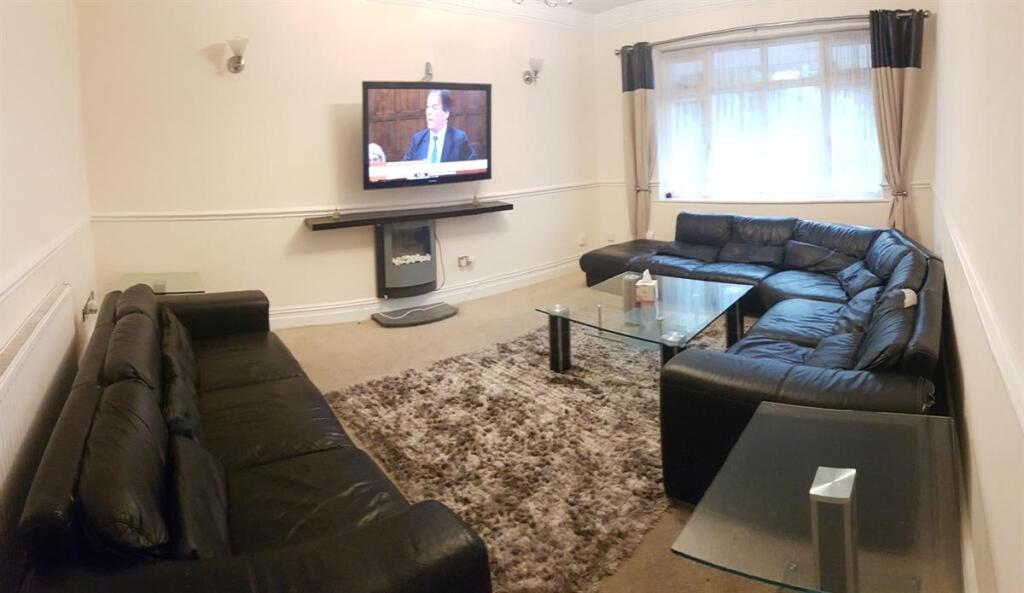 Bright, well-furnished living room with two lar...
