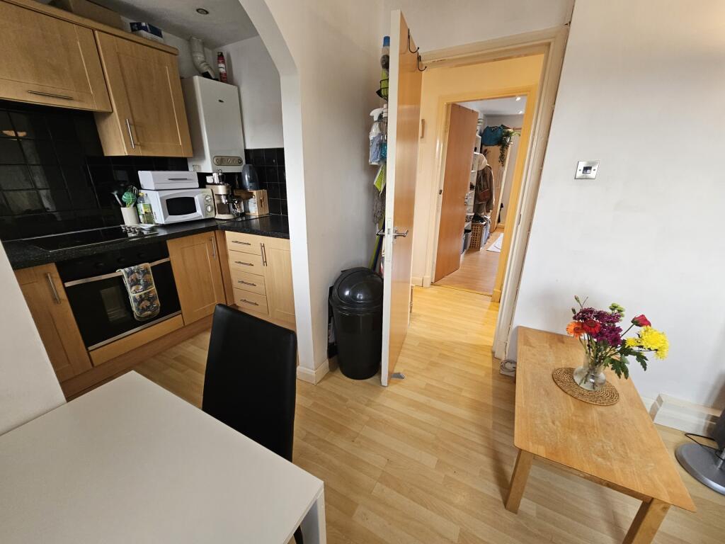 A bright and welcoming kitchen area featuring w...