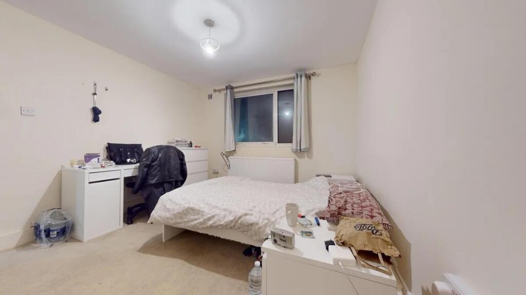 A cozy double bedroom featuring a comfortable d...