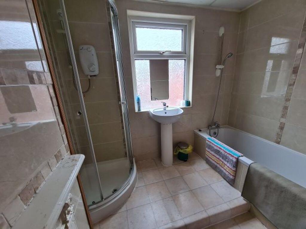 A clean and modern bathroom suite featuring a s...