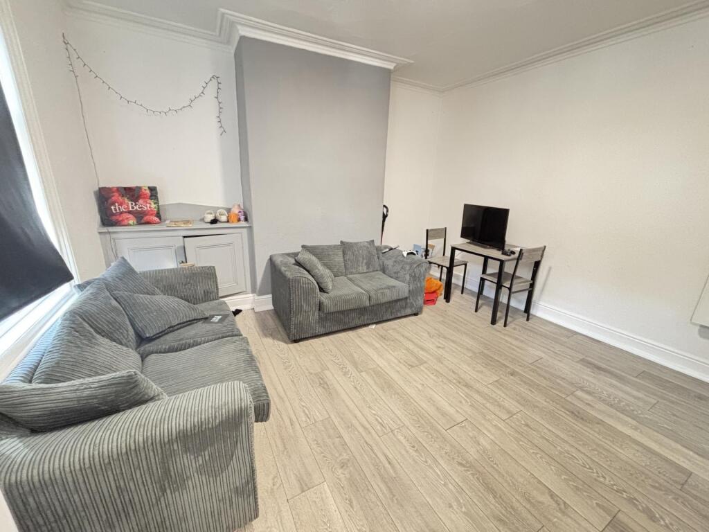 A spacious and well-maintained living room feat...