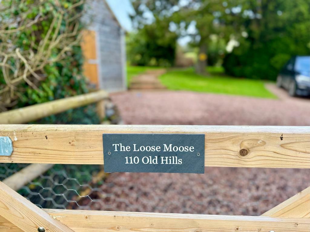 Entrance gate, garage &amp; parking area