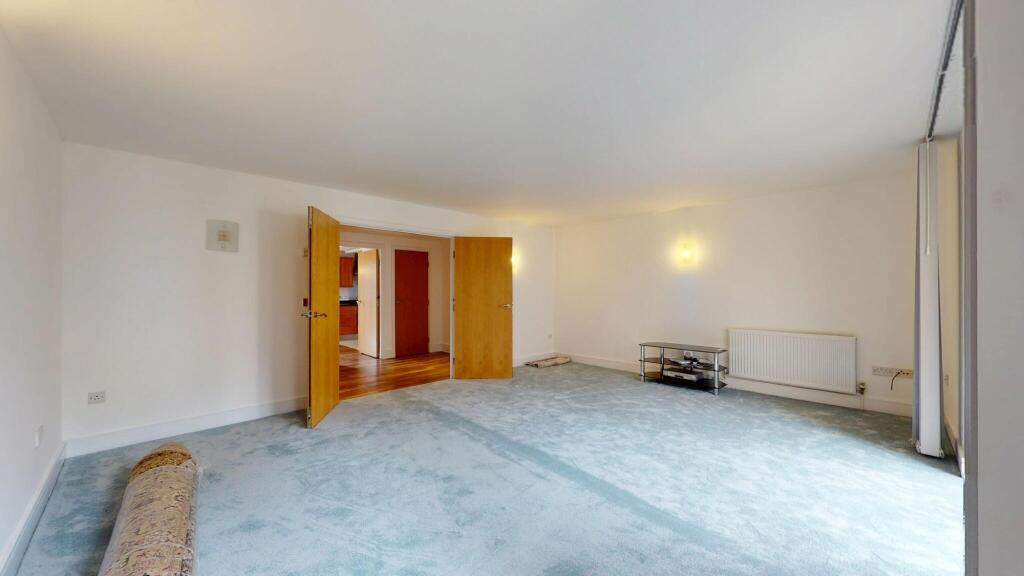 Bright and spacious living room with ample natu...