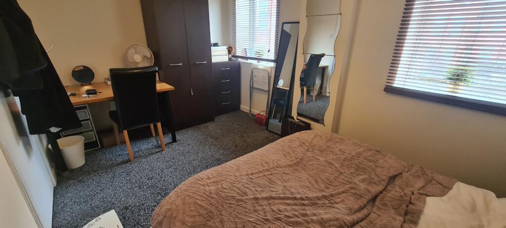 A cozy bedroom featuring a comfortable bed with...