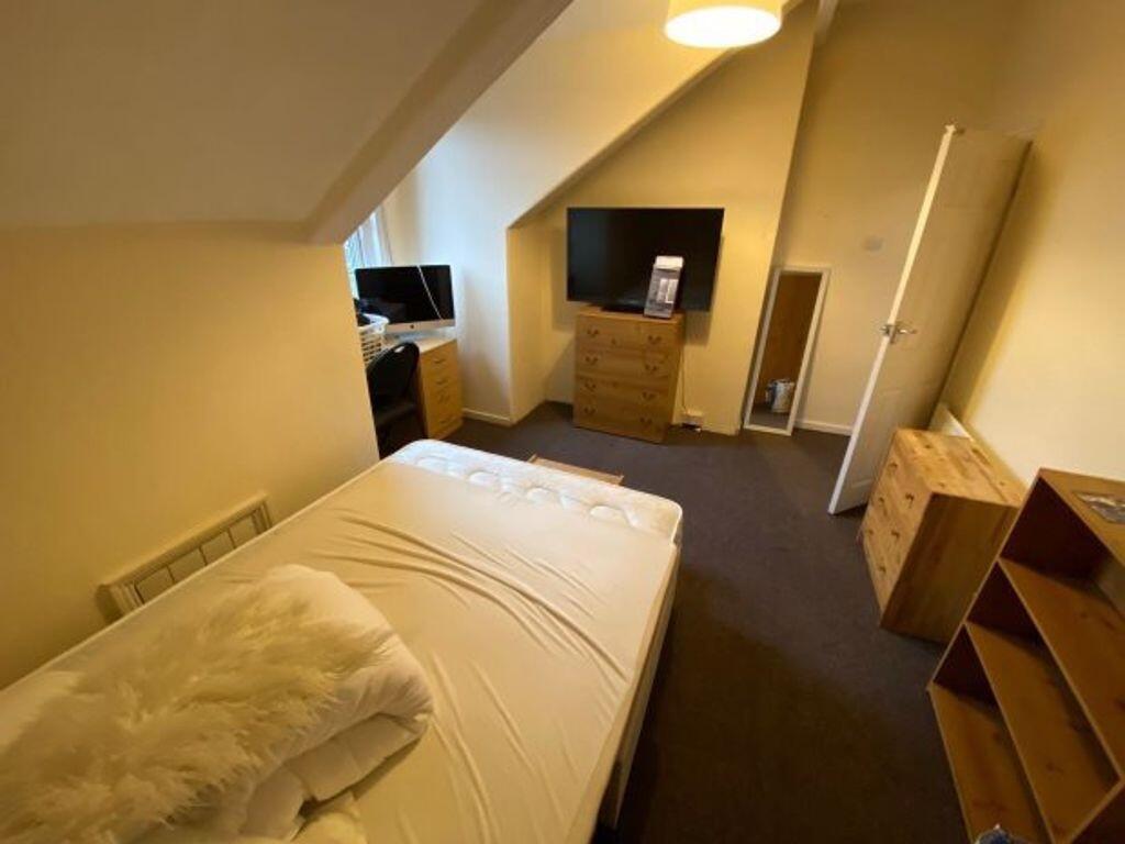 Cozy upstairs single bedroom with sloped ceilin...