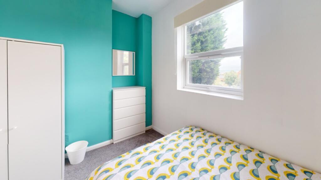 A bright and inviting double bedroom featuring ...