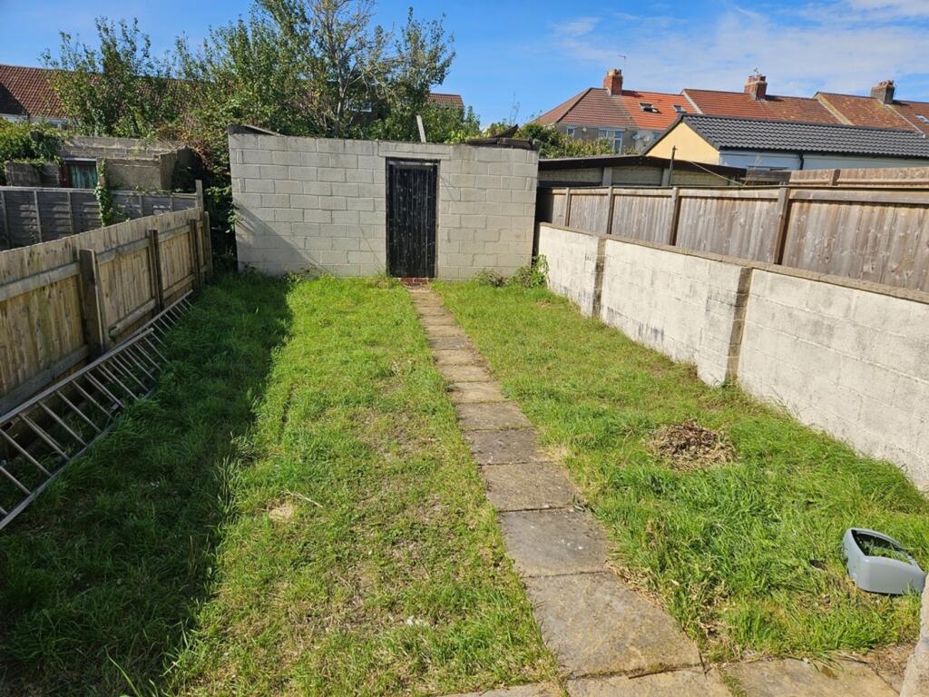 A spacious garden with a well-defined pathway, ...