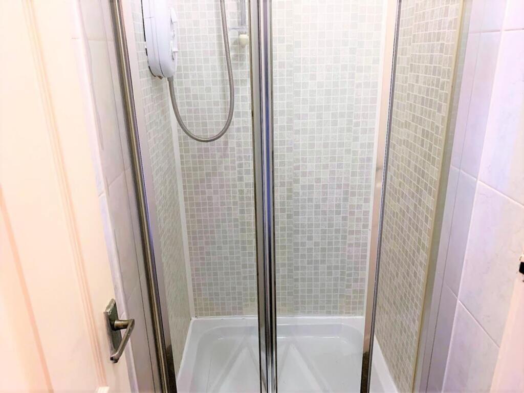 A modern bathroom featuring a sleek shower encl...