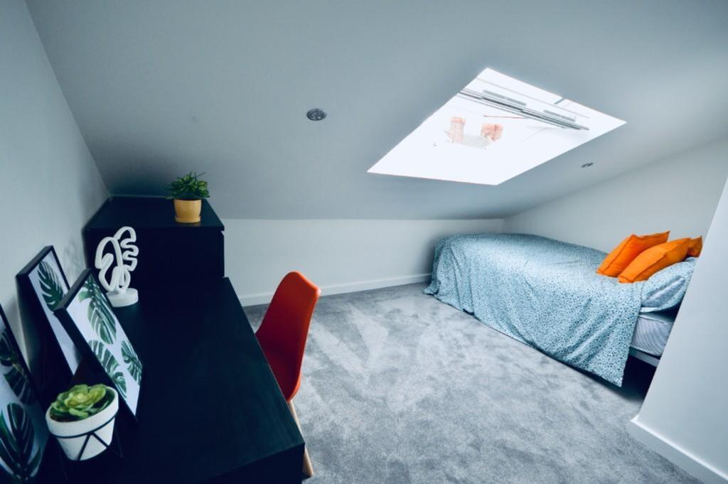 A bright and stylish double bedroom featuring a...